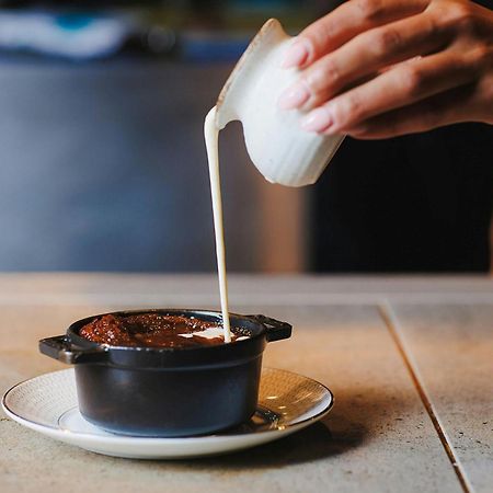 Stock Exchange Hotel Manchester Exteriör bild A pot of chocolate pudding being topped with cream