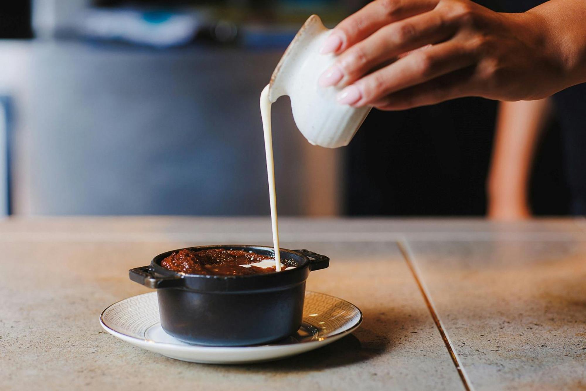 Stock Exchange Hotel Manchester Exteriör bild A pot of chocolate pudding being topped with cream